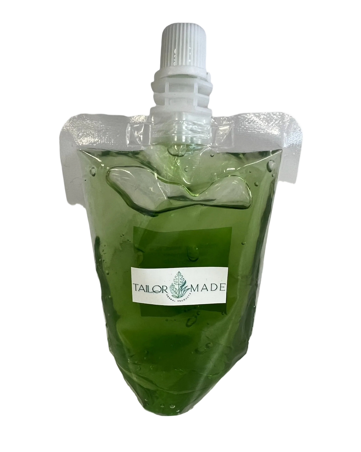 A green translucent gel-filled squeeze pouch with a white screw cap, shown on a plain white background. A white label on the front reads 'TAILOR MADE' with a small green anchor graphic.