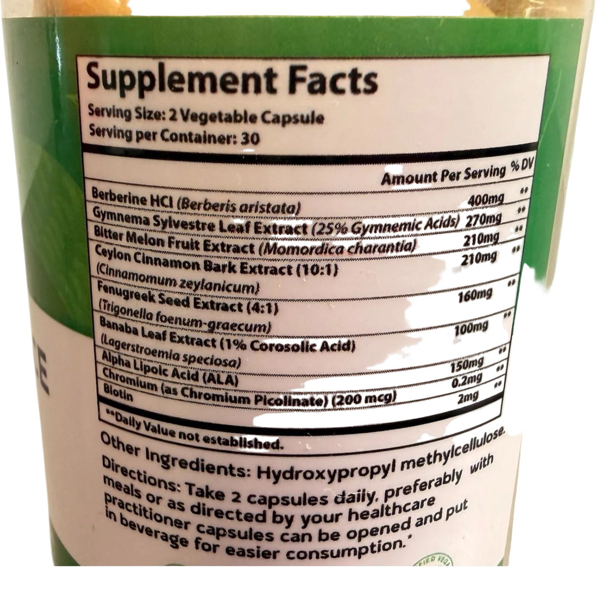 Supplement facts label on a container with green and white design.