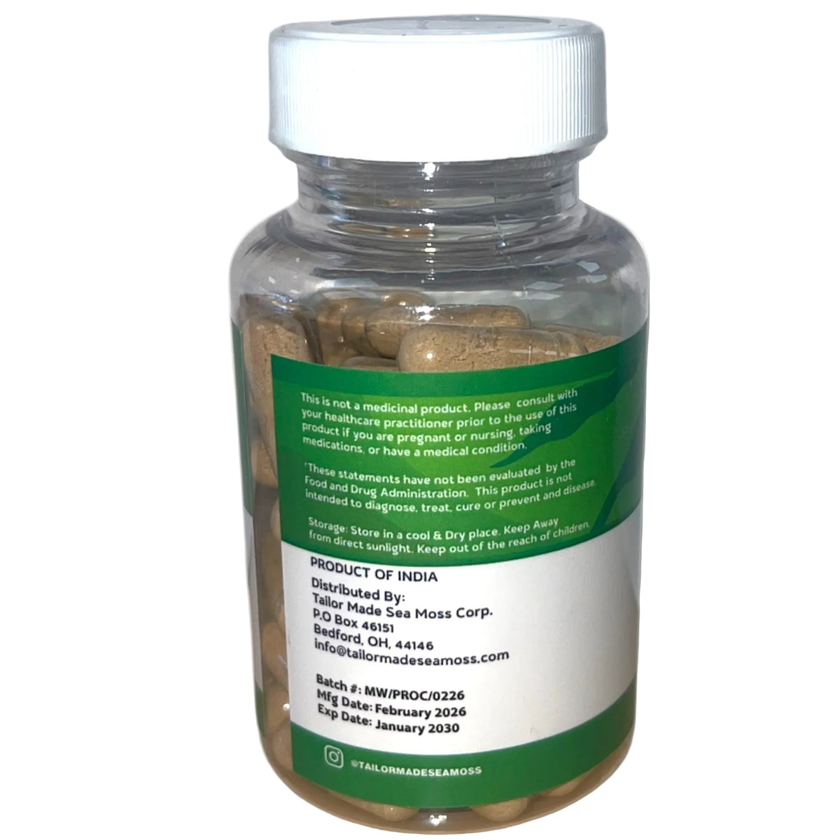 Bottle of capsules with a green label on a white background