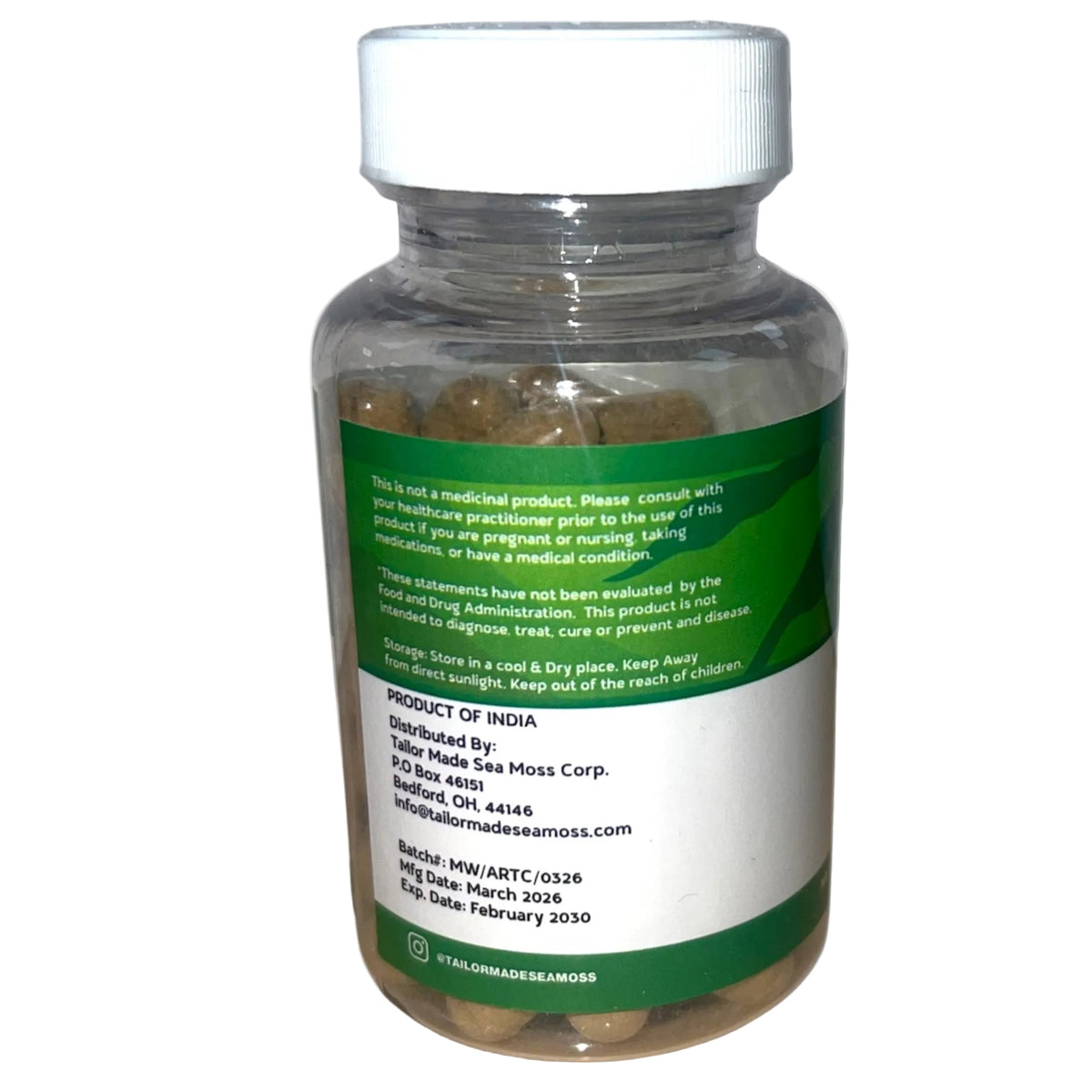 Bottle of capsules with a green label on a white background