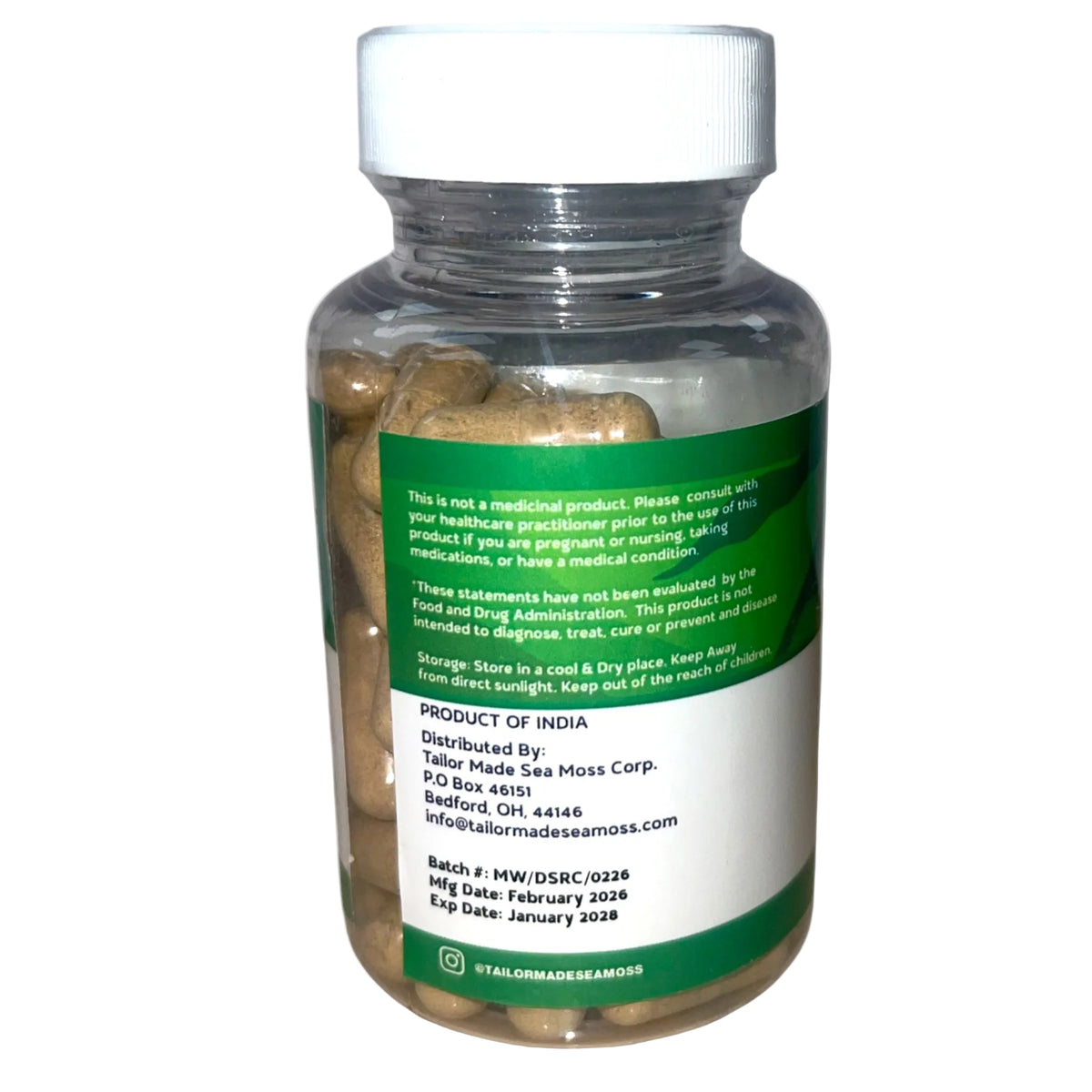 Bottle of capsules with a green label on a white background